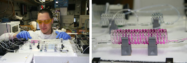 Left: Mark behind the autoanalyser; the autosampler is out of image to the right, extracting water from the samples that then travels via the pumps (right hand-side) to the mixing coils (centre of image) and finally the spectrophotometers (left). There are three parallel routes through the instrument, one for each nutrient<br />Right: coil from the autoanalyser, with a coloured mixture of seawater and reagent passing along