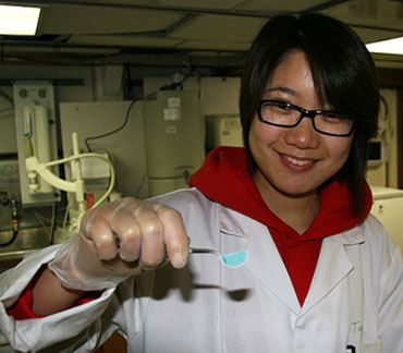 Tingting holding a folded filter paper with stained TEP on it