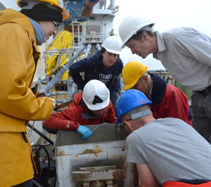 Claire, Alex, Henry, Alan, Gordon and Andy examine the sediment retrieved by the box corer