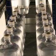 The tops of the bottles poke through holes in a Perspex sheet, to keep them from moving about in rough weather