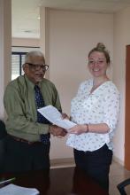 UB’s President Professor Emeritus Clement Sankat and the NOC's Stacey Felgate at the signing