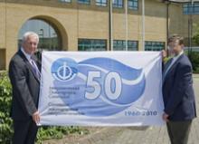 Trevor Guymer, head of the UK-IOC office presents a 50th anniversary flag to Robin Plumley, Research Ship Manager