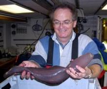 David Billett holds a large sea cucumber