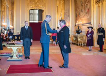 Professor Ed Hill receiving CBE insignia from HRH The Duke of Cambridge and Windsor Castle. 