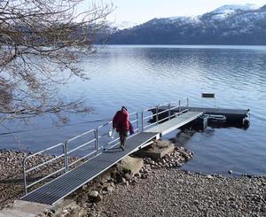 David Pugh about to install a pressure sensor under a floating pier on the north shore of Loch Ness