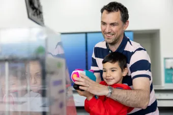 A family enjoying interactive exhibits at NOC's Open Day. 