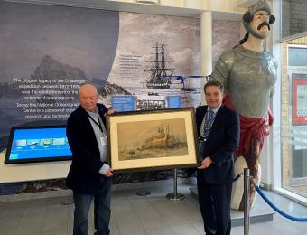 Martin Bosher handing over the framed print of the HMS Challenger to Professor Ed Hill at the NOC
