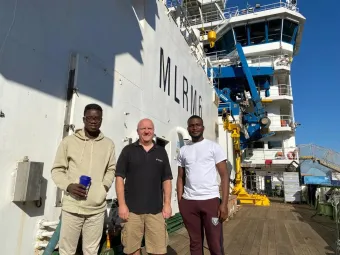 Adeola Dahunsi and Selasi Yao Avornyo (students in last year’s bursary programme) with NOC's Dr Ben Moat