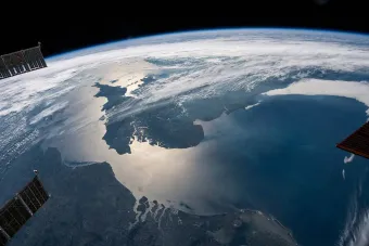 The sun’s glint beams across the English Channel and the North Sea. Photo taken from the International Space Station. Image from NASA Johnson.