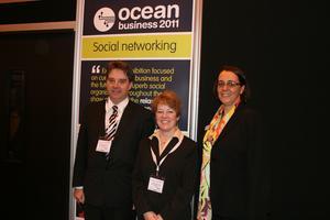 Prof. Edward Hill (NOC, left), Dr Wendy Watson Wright (IOC), and Versha Carter (Intelligent Exhibitions Ltd)