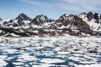 Sea ice breaking up in spring. Near Kulusuk, Greenland. iStock.com/ steve_is_on_holiday
