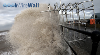 Overtopping water about to impact the WireWall system during a trial deployment at Crosby.