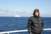 Alfred on the deck of RRS James Cook, iceberg in background