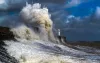 Waves crashing into a seawall. 